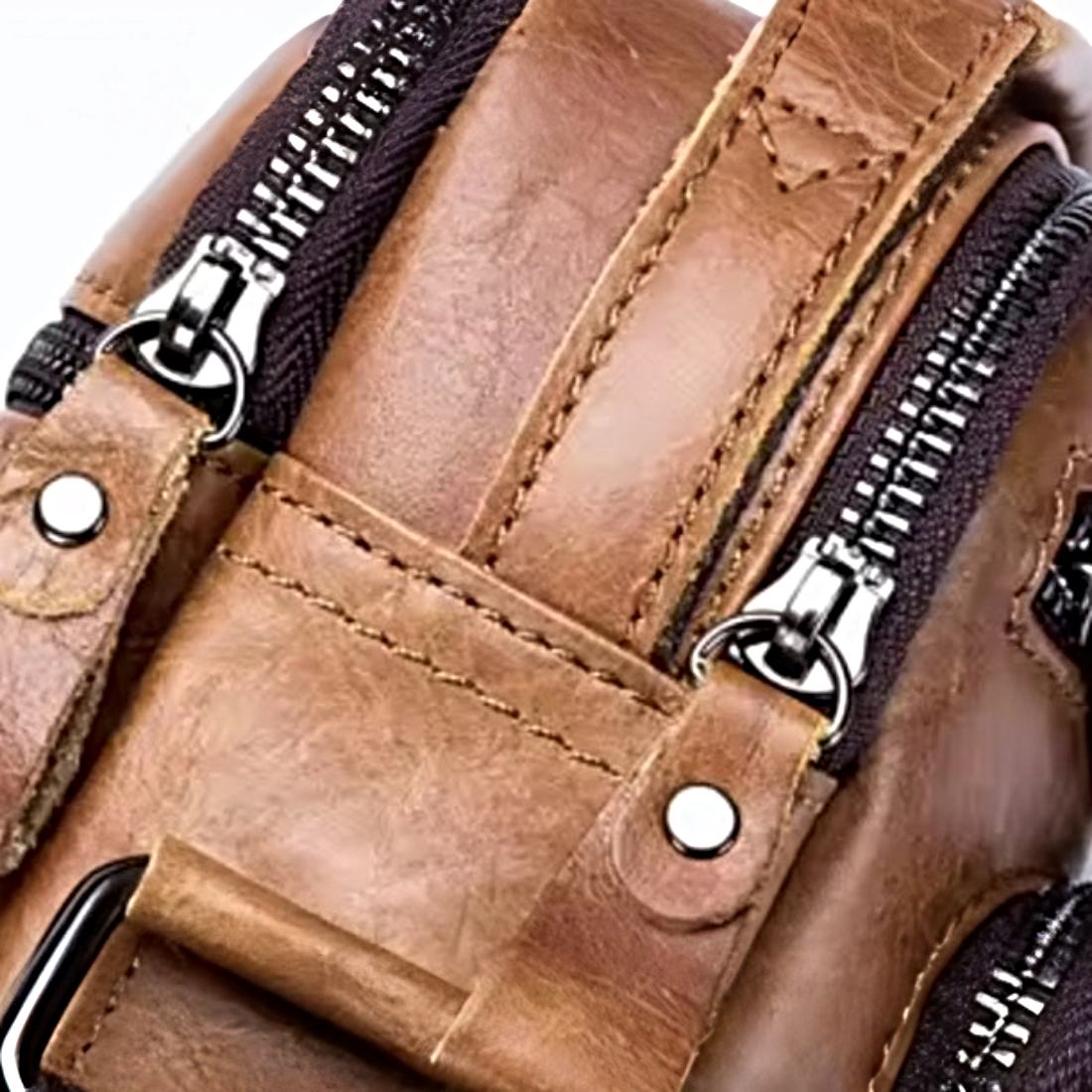 Timeless Axis Crossbody in brown close up durable genuine leather with reinforced stitching and dual metal zippers