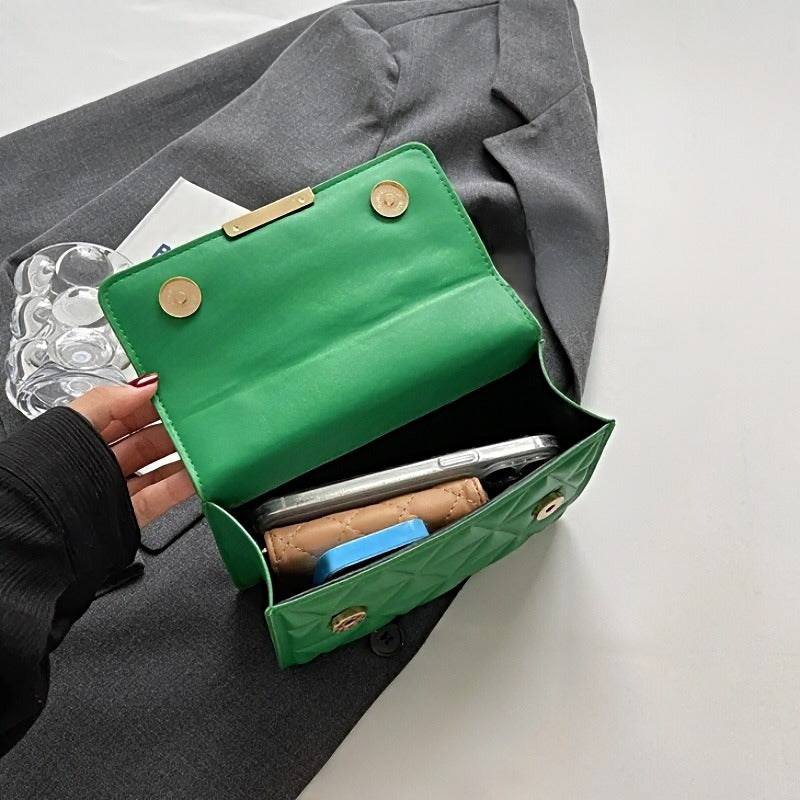Timeless Chain Crossbody women’s green vegan leather chain crossbody bag open, showing contents inside