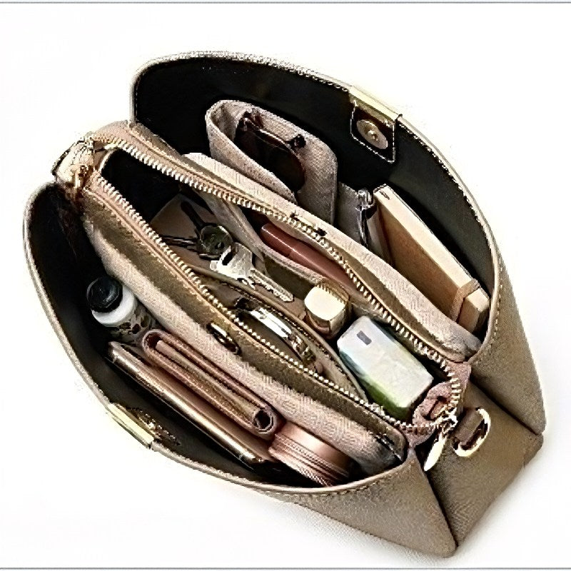 Urban Classic Carry women’s tote bag in taupe pebbled leather with gold hardware and zippered interior pockets packed with essentials