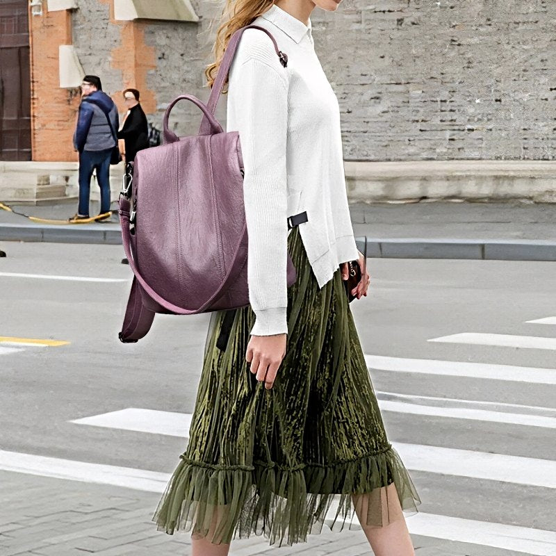 Urban Ease Backpack, women's vegan leather backpack with silver hardware in mauve worn on shoulder
