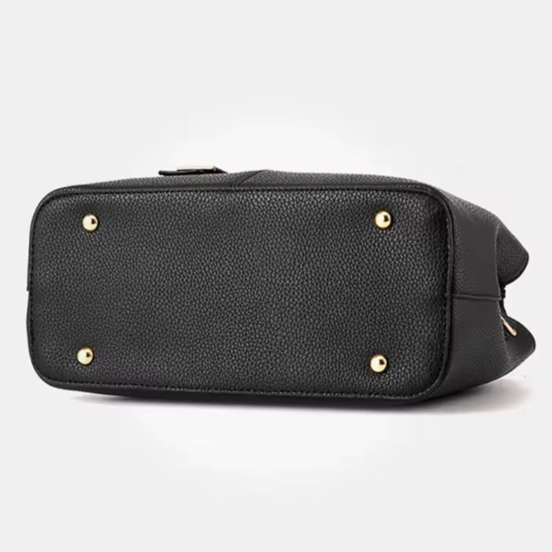 Urban Elegance Satchel in black vegan luxury leather shown from bottom view with structured base and four gold tone metal feet rivets showcasing protective design refined craftsmanship and durable premium construction for elegant elevated everyday use