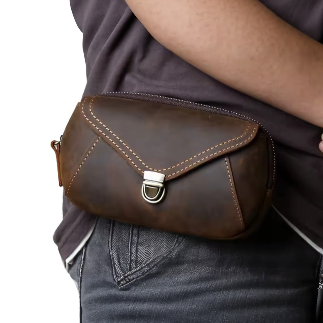 Heritage Utility Carry in dark brown genuine crazy horse leather with distressed oil wax finish worn at the waist featuring triangular flap with metal clasp and visible stitching showcasing vintage styling and upscale hands free functionality