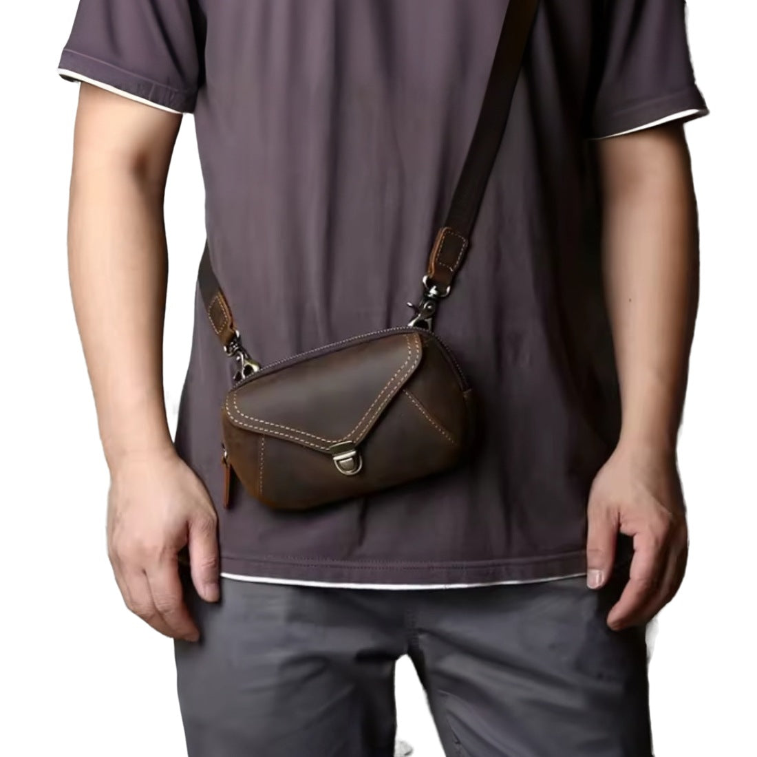 Heritage Utility Carry in dark brown genuine crazy horse leather with distressed oil wax finish worn crossbody featuring triangular flap with button closure and adjustable strap with brass clasps showcasing vintage styling and upscale hands free utility