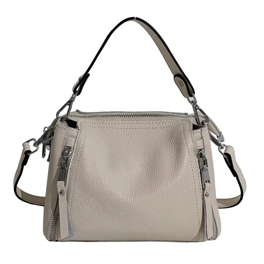 Timeless Zip Carry in beige premium genuine leather with elegant silver hardware softly structured bucket shape with secure zipper closure removable top handle and adjustable shoulder strap that can be removed highlighting sophisticated versatility and upscale design